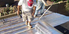 Therma Sheet Man walking up roof on Therma Sheet