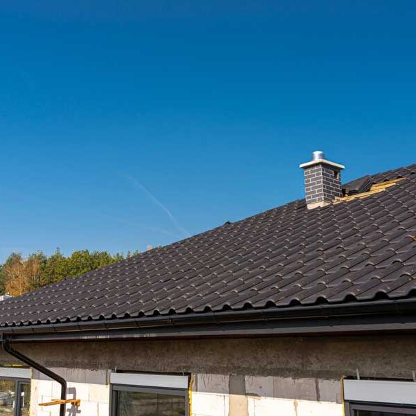 Roof of a single family house with a new ceramic tile Roofing Contractor installing ceramic tile roof