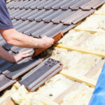 Worker installing tile roof