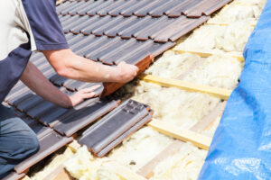 Worker installing tile roof