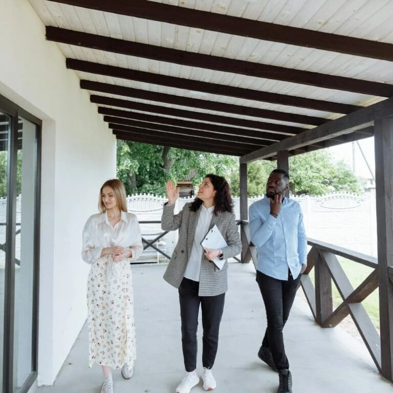 Screenshot 2024-05-31 142941 2 women and man beneath overhang roof, walking, looking up
