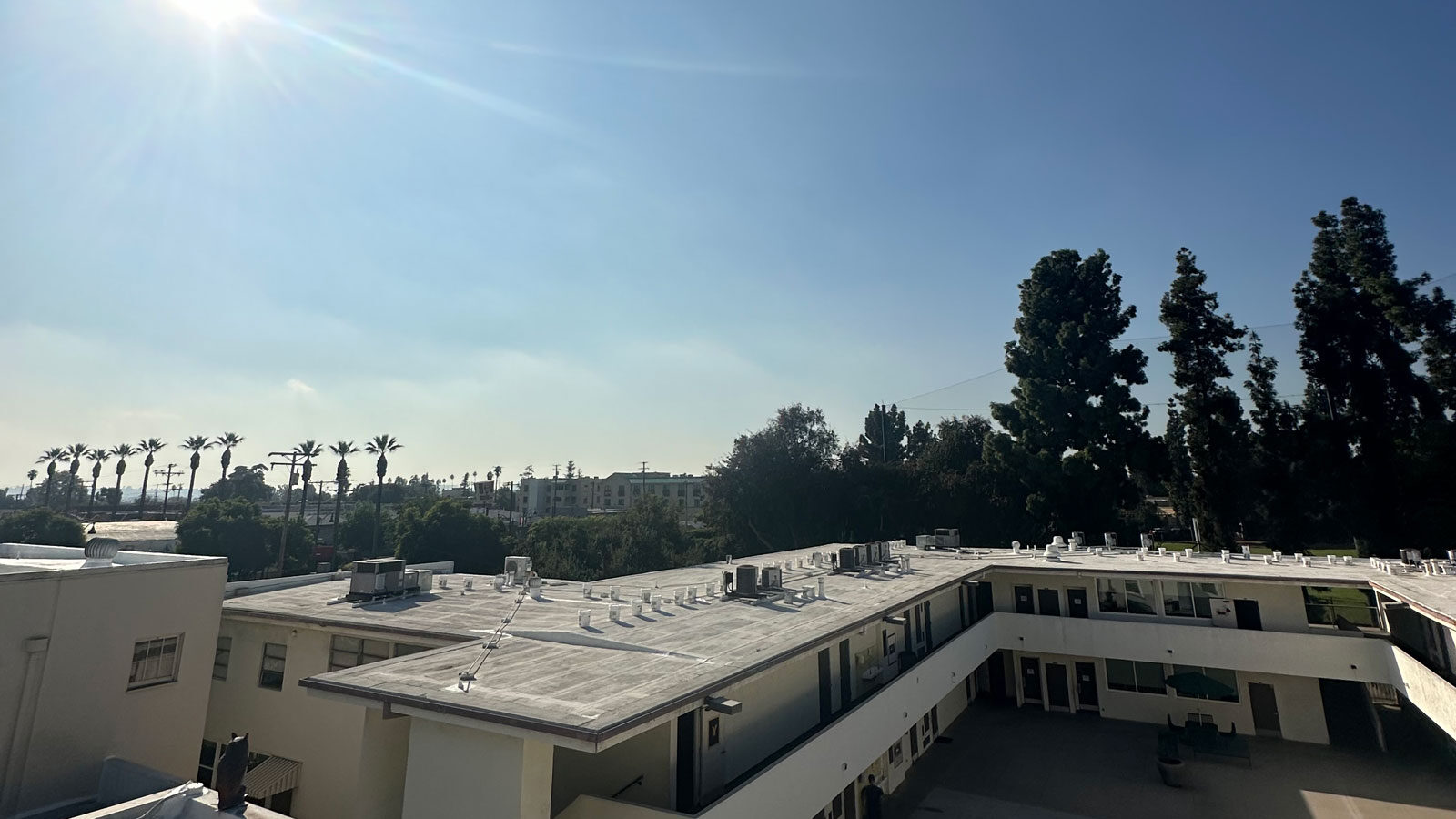 Cool white roof with sun shining down on the roofs.