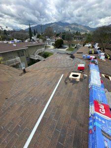 Roof being work on with roofing materials.