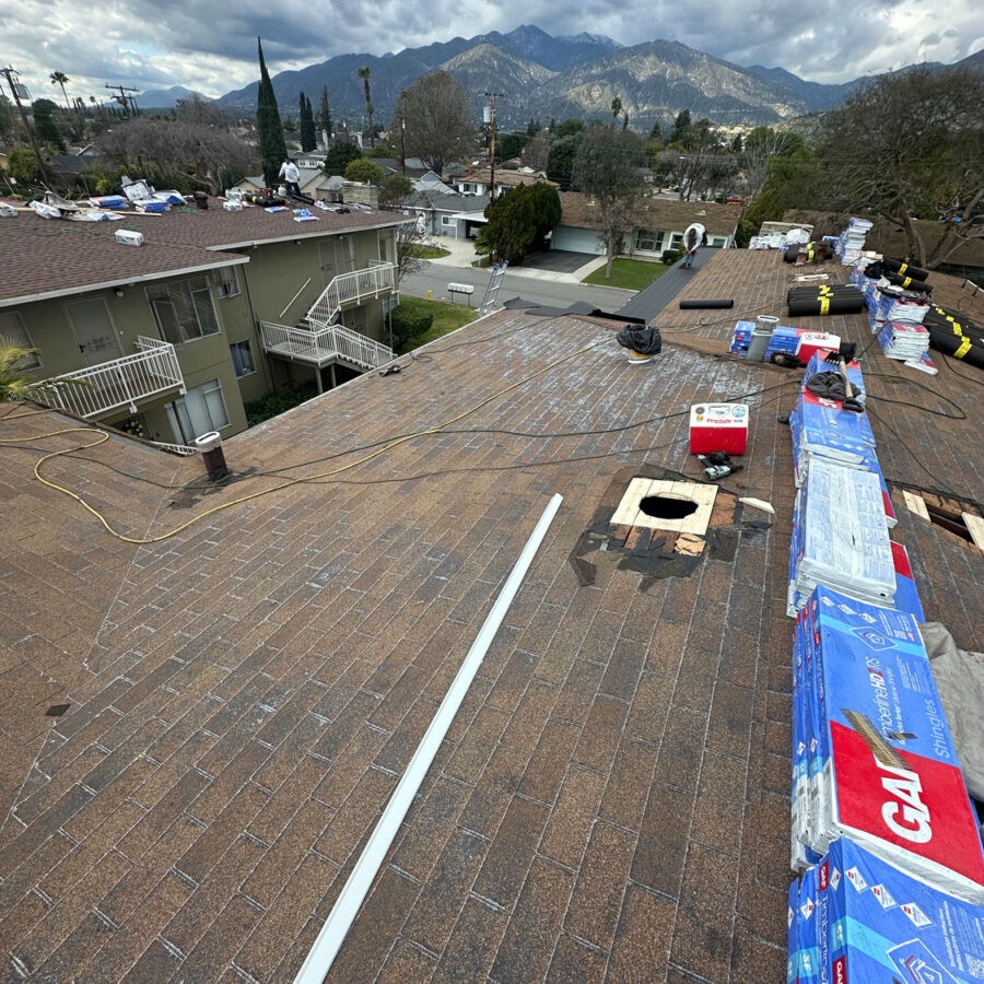 Roof being work on with roofing materials.