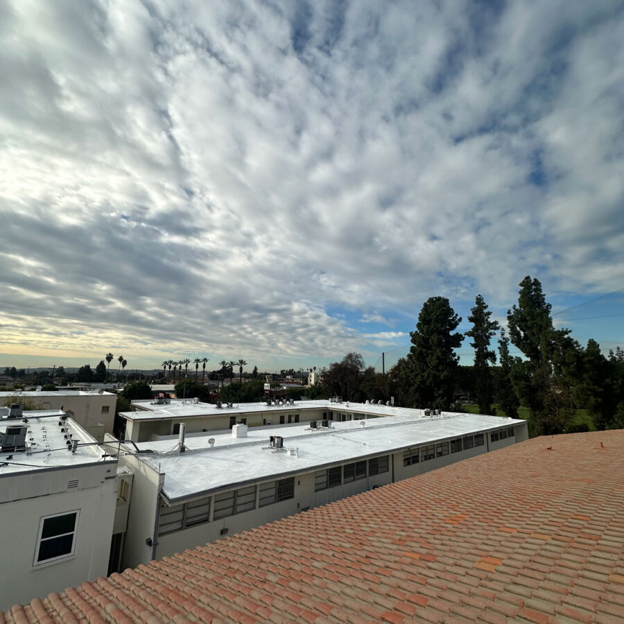 Clay roof with clouds in the background.