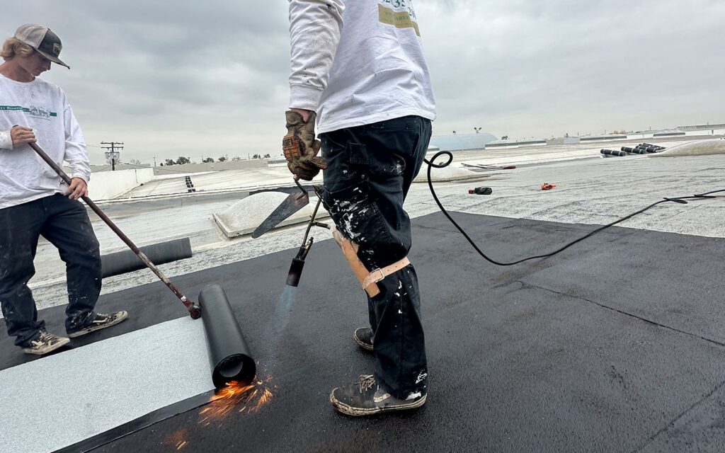 Workers installing a commercial roof.