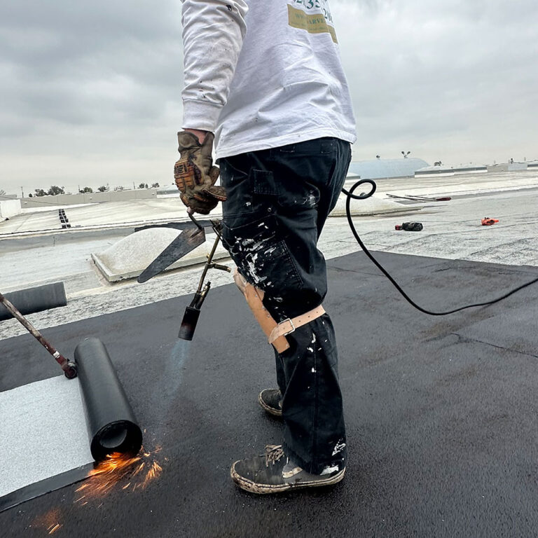Workers installing a commercial roof.