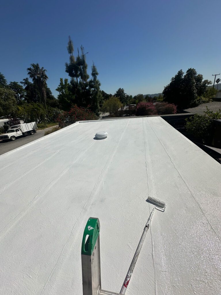 Finished residential roof painted white.