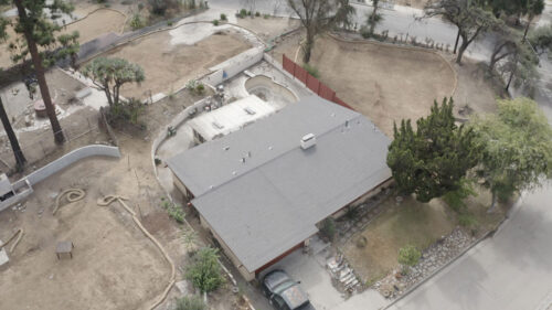 Ariel view of a house that survive the Eaton fires using roof fire protection from Garvey Roofing.