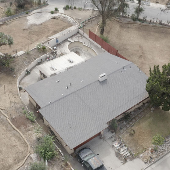 Ariel view of a house that survive the Eaton fires using roof fire protection from Garvey Roofing.