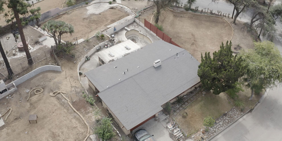 Ariel view of a house that survive the Eaton fires using roof fire protection from Garvey Roofing.