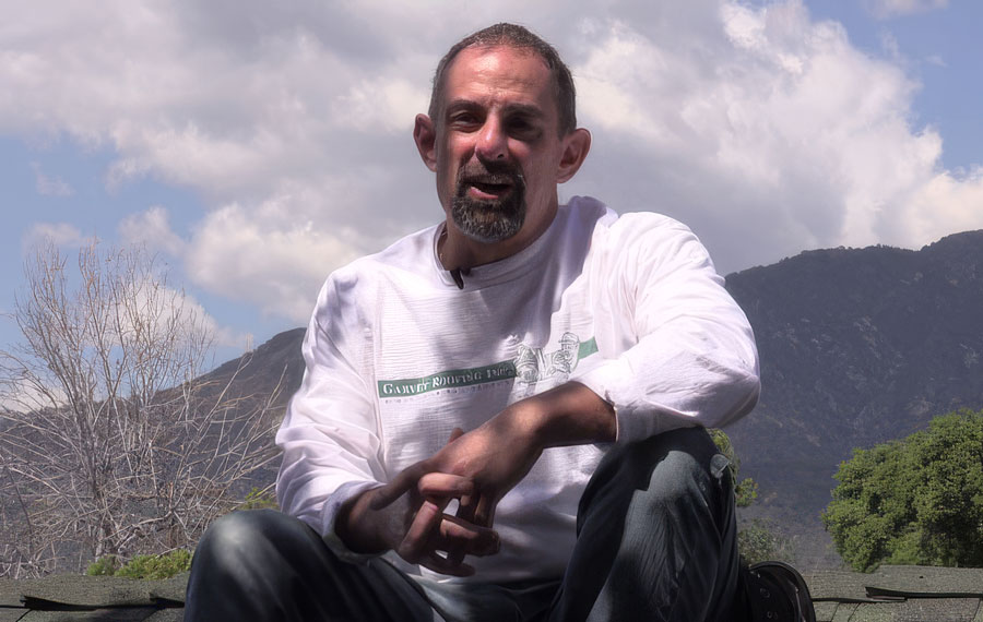 Thomas Garvey, owner of Garvey Roofing sitting on a roof.