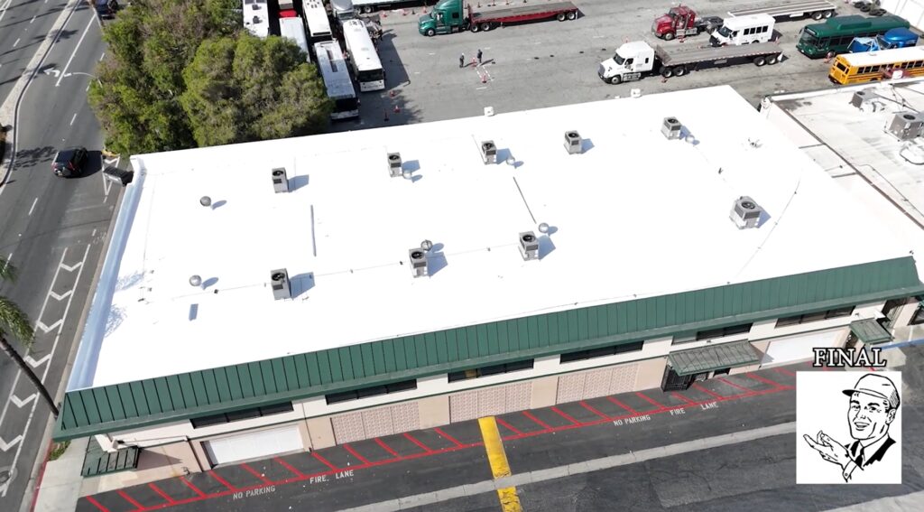 White silicone roof being installed on a commercial building.