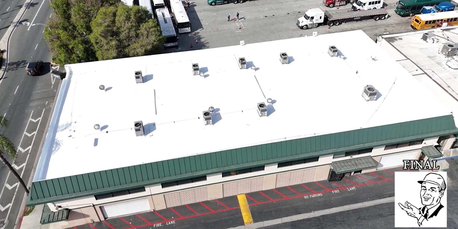 White silicone roof being installed on a commercial building.