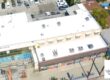 White silicone roof being installed on a commercial building.