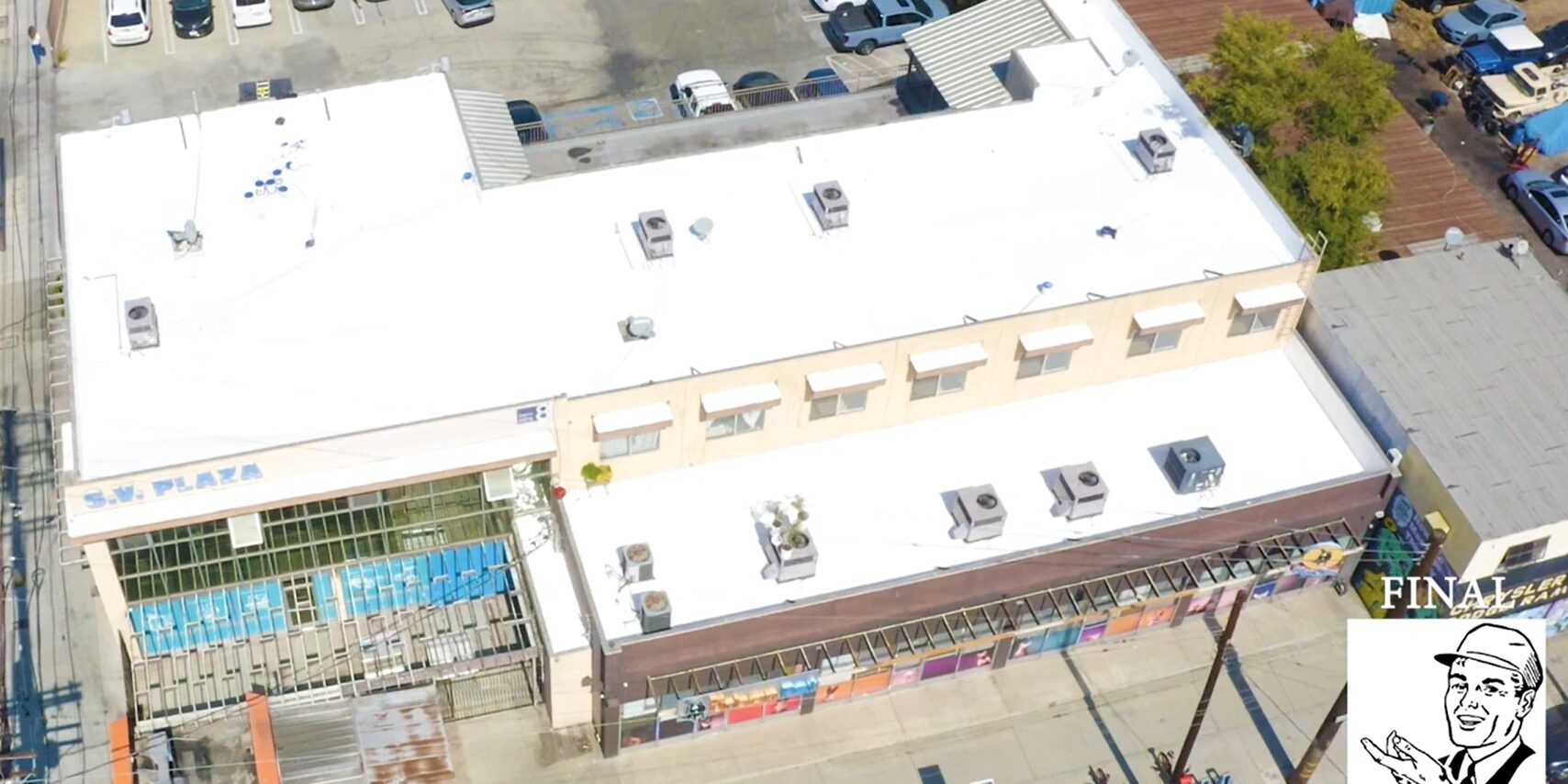 White silicone roof being installed on a commercial building.
