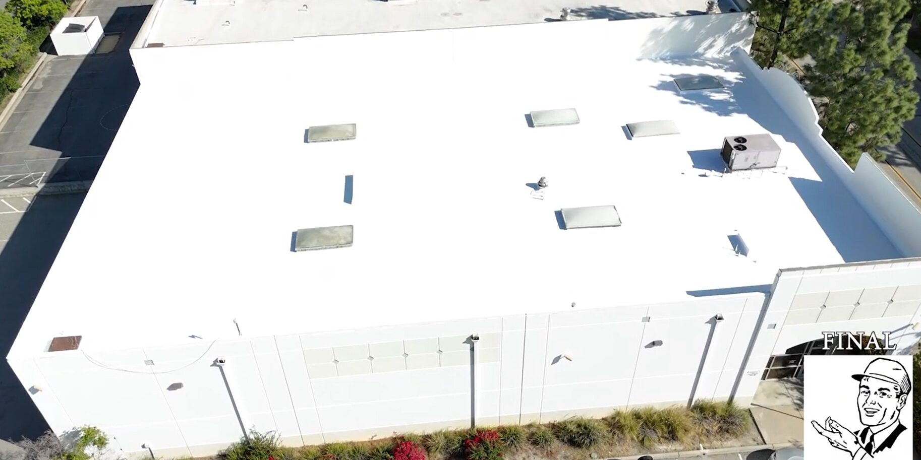 White silicone roof being installed on a commercial building.