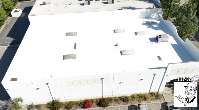 White silicone roof being installed on a commercial building.