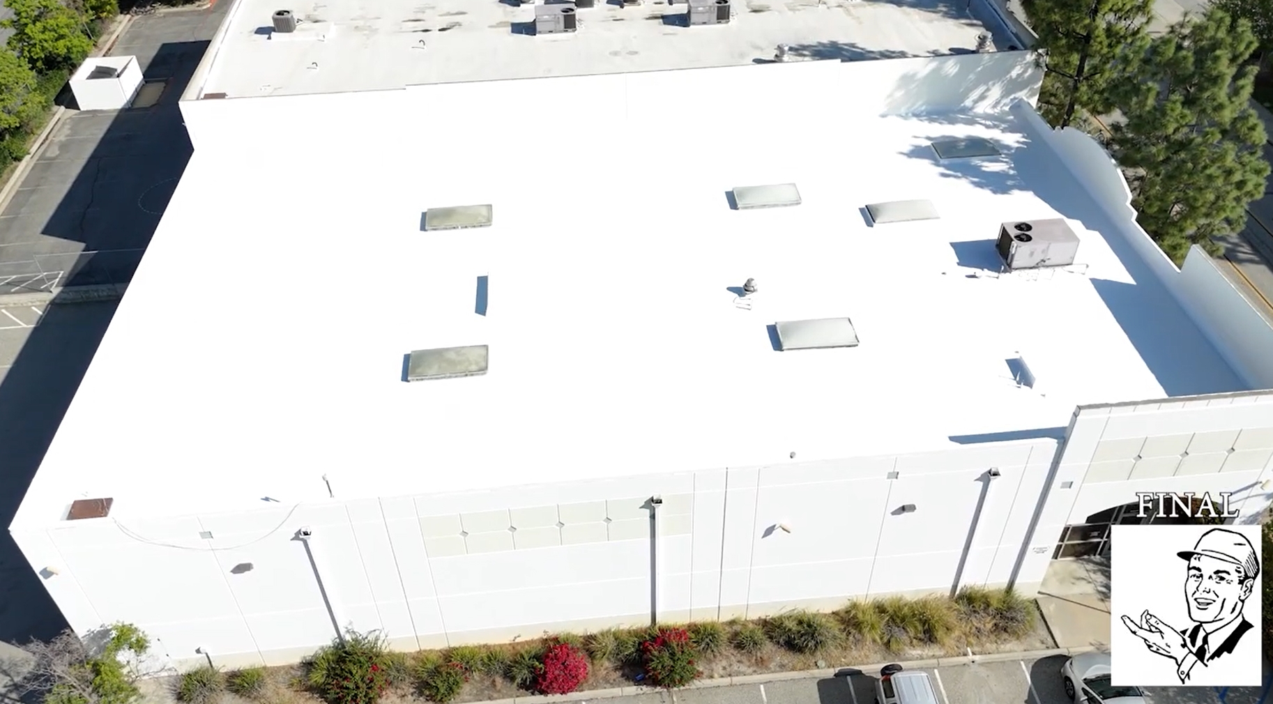 White silicone roof being installed on a commercial building.