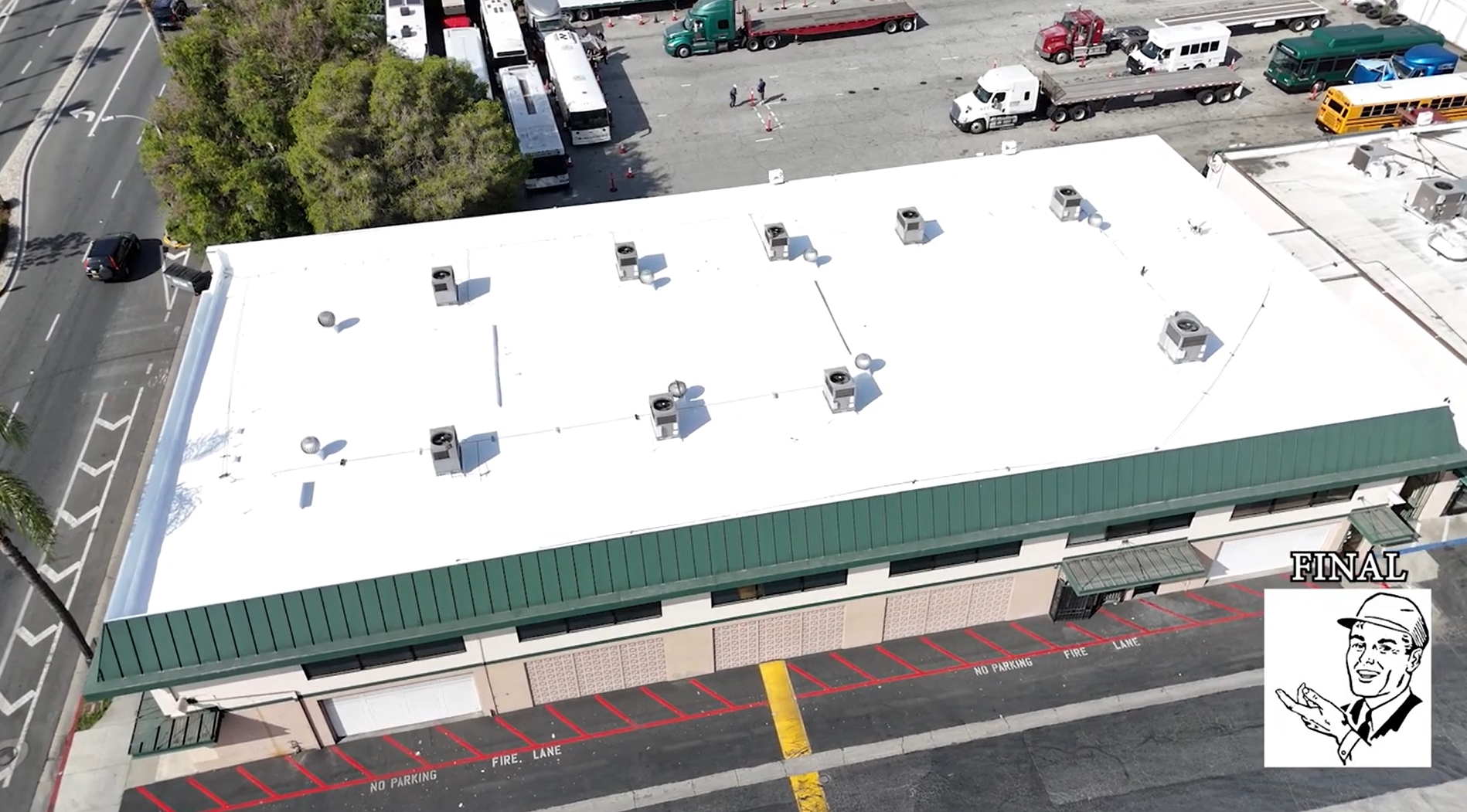 White silicone roof being installed on a commercial building.
