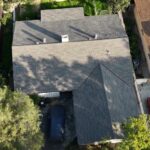 Shingle roof being installed on a residential house by Garvey Roofing Inc.