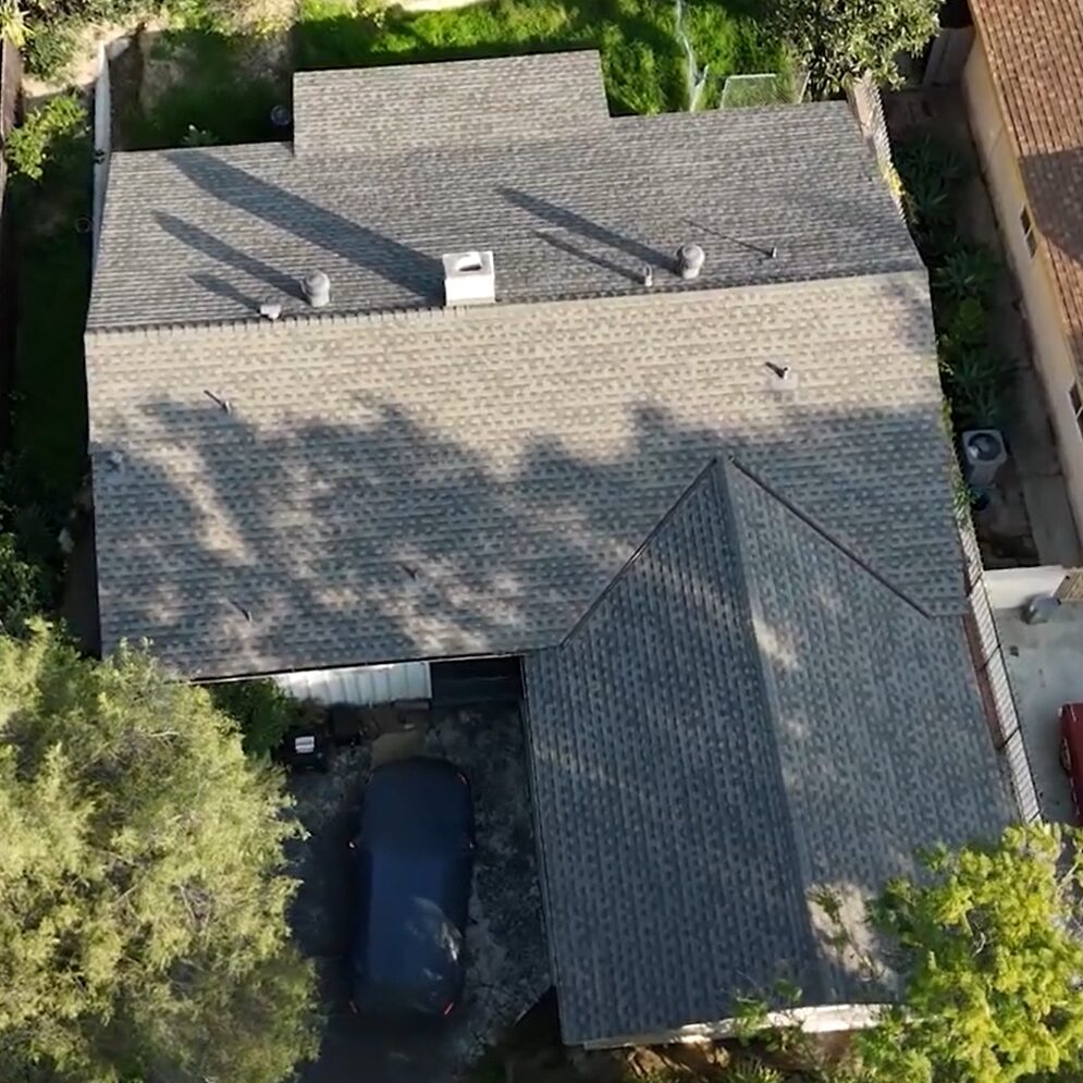 Shingle roof being installed on a residential house by Garvey Roofing Inc.