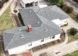 Shingle roof being installed on a residential house by Garvey Roofing Inc.