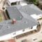 Shingle roof being installed on a residential house by Garvey Roofing Inc.