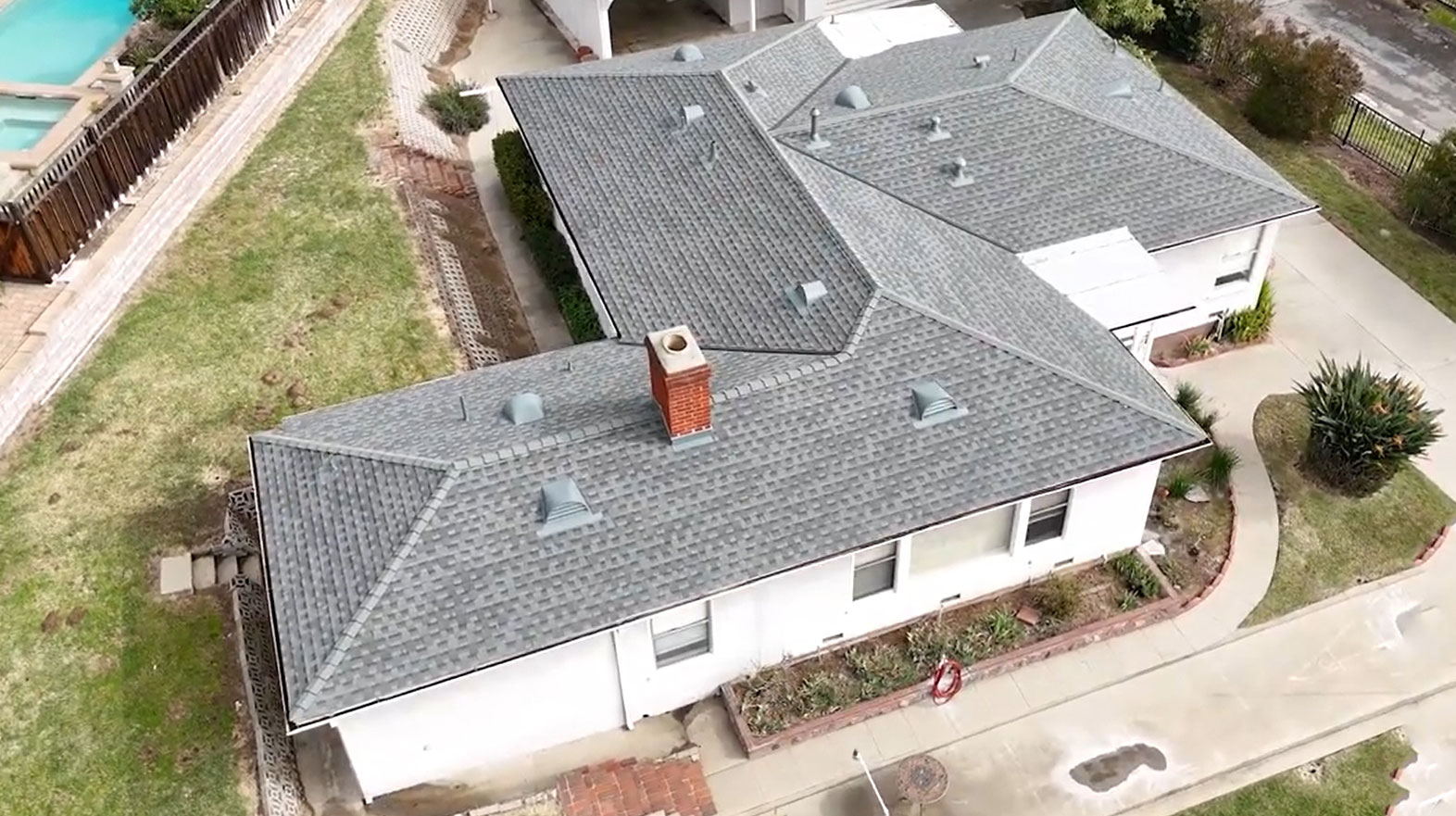 Shingle roof being installed on a residential house by Garvey Roofing Inc.