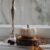 Pumpkin, lampstand near window covered in rain
