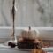 Pumpkin, lampstand near window covered in rain